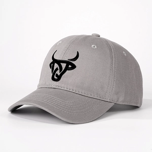 Adjustable grey cotton baseball cap with black embroidered bull head logo, 45-degree view