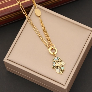 Double-layered gold stainless steel Hamsa hand necklace with blue enamel evil eye charm