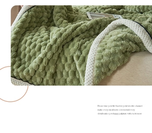 Detail of pea green bubble plush blanket with soft white sherpa fleece lining and thick texture