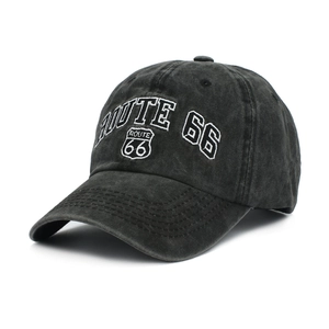 Close-up of ROUTE 66 white embroidery and stitching on washed black denim baseball cap