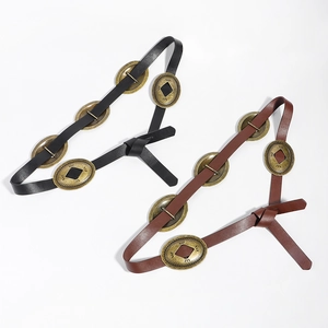 Detail of vintage waste-land style belts with oval metal buckles in black and brown leather