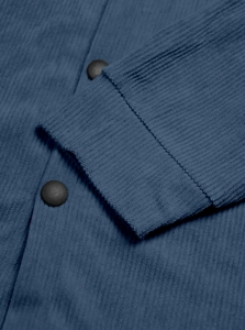 Detailed macro view of dark blue corduroy shirt cuffs with round black buttons