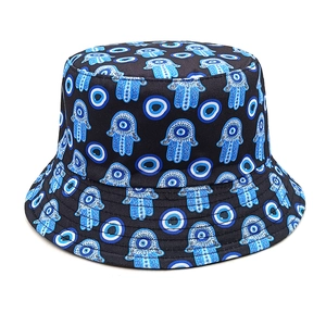 Detail of Hamsa Hand and Evil Eye print on black canvas bucket hat fabric