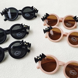 Kids bat-shaped round sunglasses with UV400 protection in black and pink matte frames