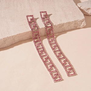 Detailed view of pink rhinestone geometric earrings featuring Greek key patterns on stone
