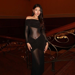 Detail of elegant black off-shoulder maxi dress with sheer mesh long sleeves and slim fit