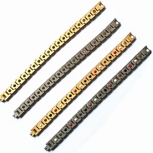Detail view of four magnetic steel bracelets in gold and silver with inlaid gemstones