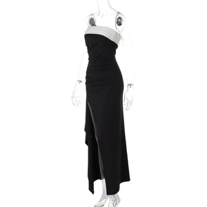 Detail of off-shoulder slim fit dress featuring a high side slit and black-white contrast