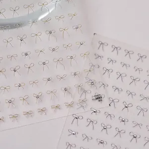 3D Kristall-Schleifen Nagelaufkleber in Gold und Silber mit Strasssteinen auf Klarsichtfolie