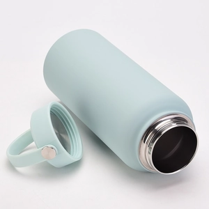 Detailed view of mint green stainless steel water bottle with lid and carrying loop