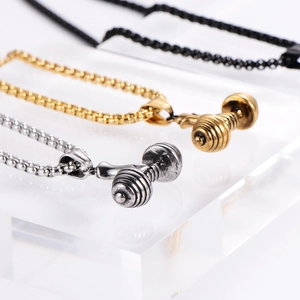 Detailed close-up showing silver, gold, and black dumbbell pendants for fitness jewelry