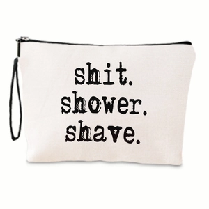 Detail of the minimalist canvas toiletry bag with black text and side handle strap