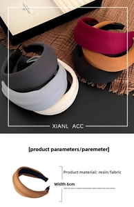 Detail of vintage-style wide padded headbands in six matte fabric colors on a tray