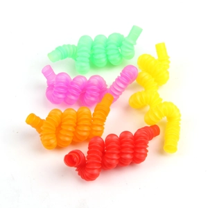 Close-up of five colorful sensory pop tubes in green, pink, yellow, orange and red