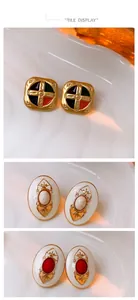Detailed view of vintage gold-plated enamel earrings with intricate relief designs