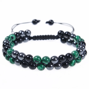Macro shot of double-layer woven bracelet with green malachite and black obsidian beads