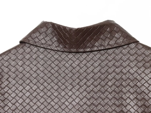 Detailed close-up showing brown woven leather texture on jacket collar and shoulder area
