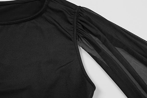 Detail of elegant black dress showing a round neck and pleated sheer mesh sleeves