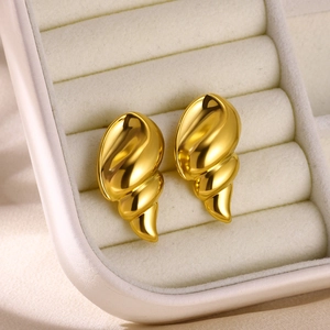 Polished gold stainless steel spiral earrings with shell texture on beige velvet box