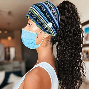 Detail of blue paisley yoga headband with side buttons to hold face mask straps securely