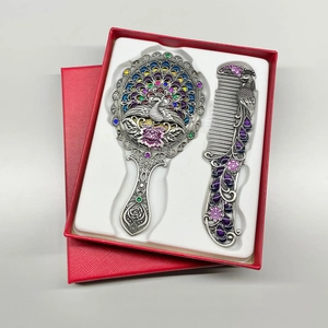 Detail view of peacock vanity mirror and comb set with rhinestones in a red gift box