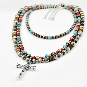 Detailed view of Navajo style beaded necklace with turquoise and silver cross pendant