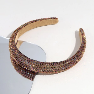 Detailed macro view of colorful rhinestones on a thick baroque velvet headband