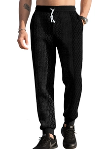 Detail of men's black waffle knit pants showing unique diamond texture and drawstring