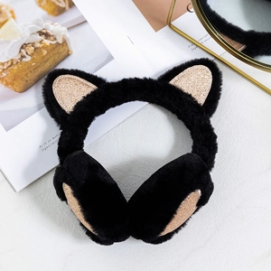Detail of plush black cat ear earmuffs with glittering gold sequin accents for winter