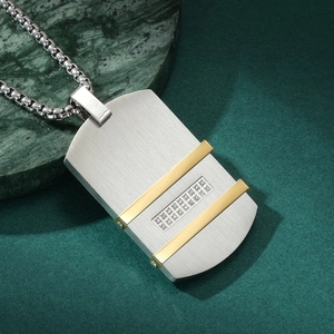 Macro detail of silver brushed rectangular military tag pendant with gold stripes and diamonds