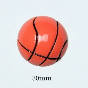 Macro shot of 30mm orange resin basketball flatback bead showing smooth texture and lines