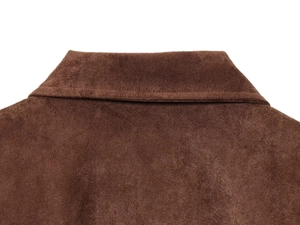 Macro detail of the dark brown faux suede collar and precision stitching on the jacket