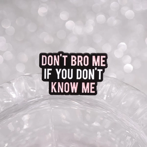 Enamel brooch with 'Don't Bro Me If You Don't Know Me' text on textured background