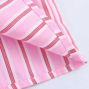 Close-up of pink striped cotton fabric with professional double-stitched hem details