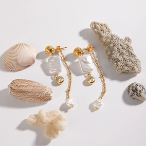 Elegant gold-tone stainless steel earrings with baroque pearls and zircon bow tassels