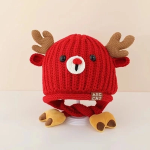 Detail of red knit baby hat featuring cute deer antlers and warm fleece lining