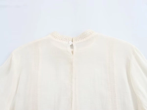 Close-up of cream lace stand collar and vertical stripe texture on woman blouse