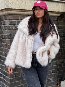 Faux fox fur warm coat with oversized lapels shown in a stylish outdoor street setting