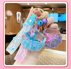 Close-up of starfish shell liquid sand keychain with mermaid tail and silicone wristband