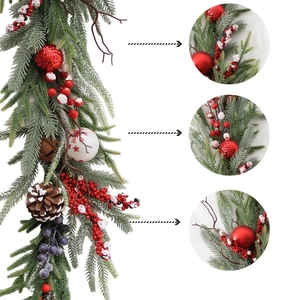 Christmas garland with red berries, pine cones and decorative balls for festive table decor