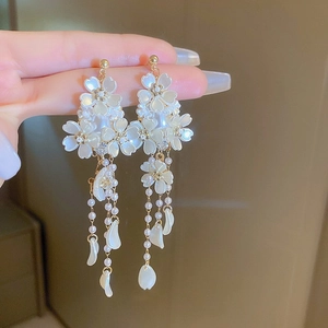 Elegant cherry blossom tassel earrings with white shell flowers and pearls in gold finish