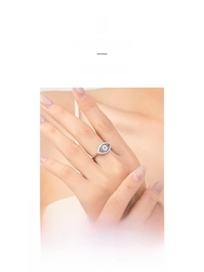 Close-up of S925 sterling silver evil eye ring with blue pave zircons on finger