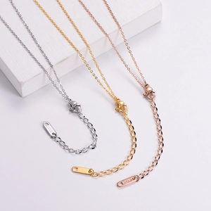 Detailed macro view of 18KGP adjustable extension chains in silver, gold, and rose gold