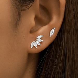 Detail view of S925 sterling silver marquise crown earrings on a female model ear