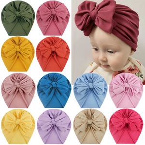 Selection of colorful baby turban hats with large bows in twelve vibrant shades