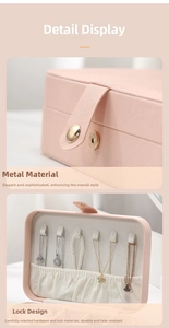 Pink PU leather jewelry box detail with golden metal clasp and necklace storage hooks
