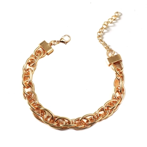 Macro detail of chunky gold chain bracelet with heavy links and lobster clasp