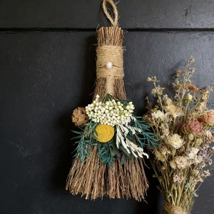 Handmade straw decorative broom with dried flowers, twine, and pearl for festive decor
