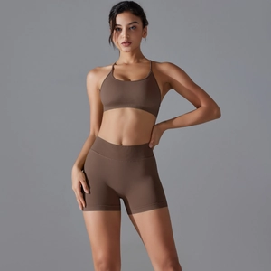 Close-up of seamless coffee brown yoga set featuring cross-back bra and high-waist shorts