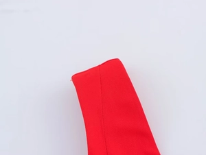 Detailed macro view of red woven fabric strap texture on the balloon mini dress